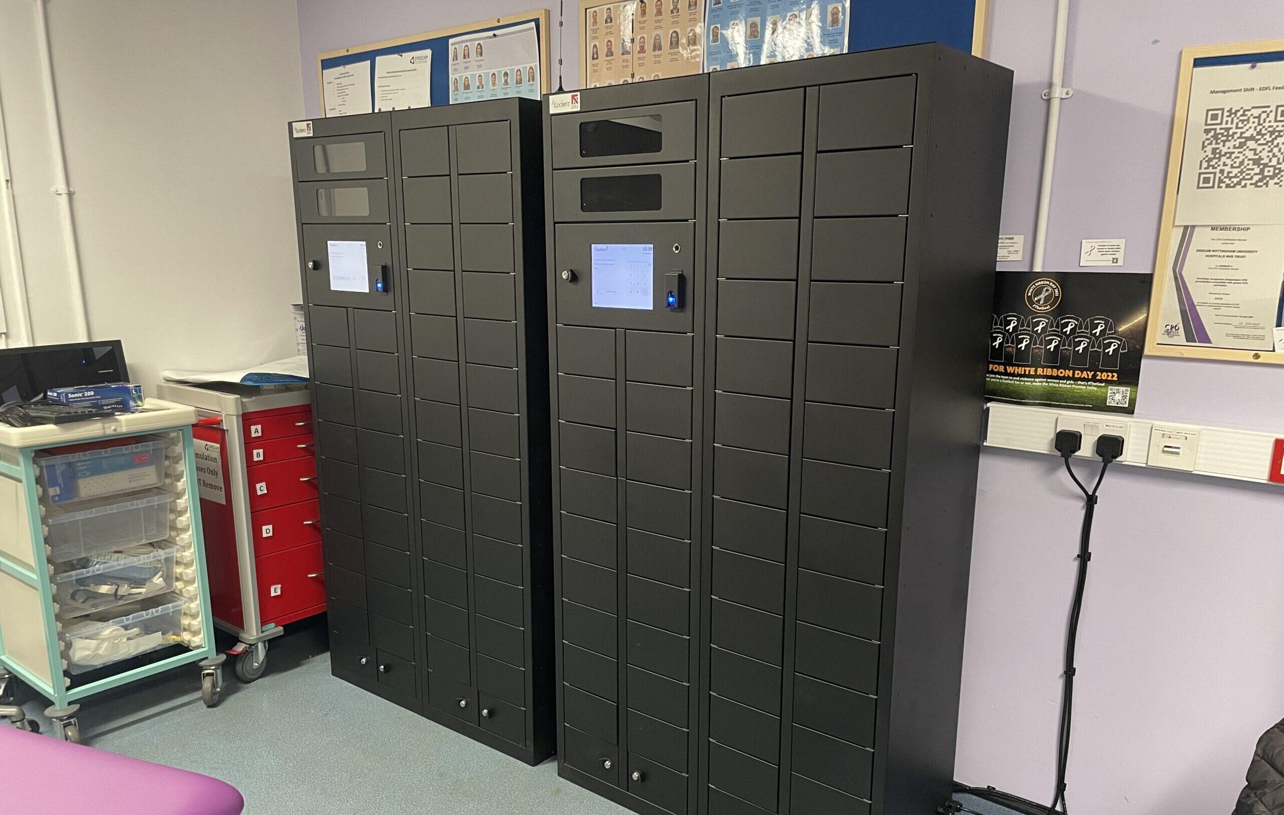 Two iLockerz smart locker banks installed at Nottingham University Hospital, featuring compact compartments and central touchscreen interfaces for the secure management of medical devices and handheld technology.